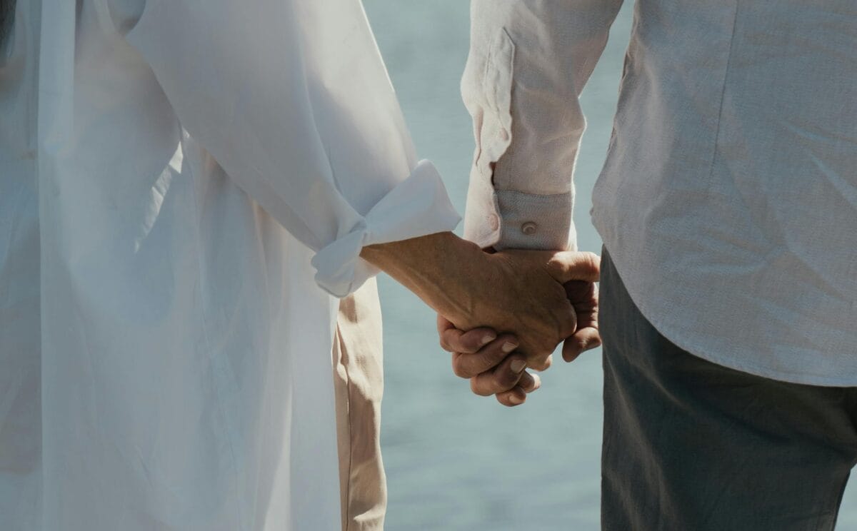 Elderly couple holding hands
