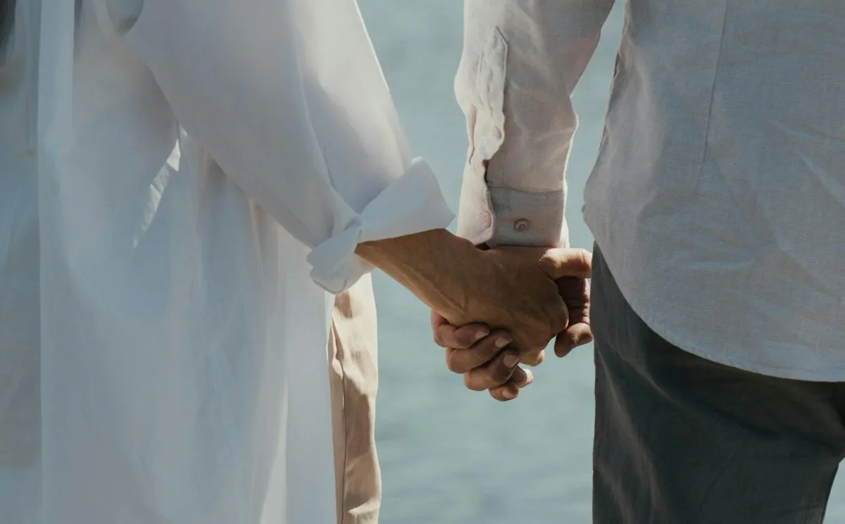 Elderly couple holding hands